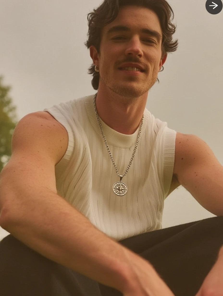 Man wearing a sleeveless shirt with a Compass Pendant necklace from Ravion 