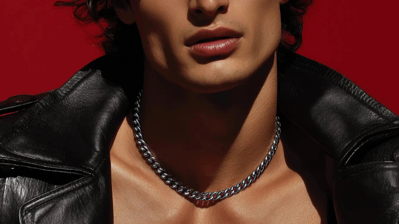 Man wearing a black leather jacket and Silver Cuban Chain chain necklace against a red background Ravion